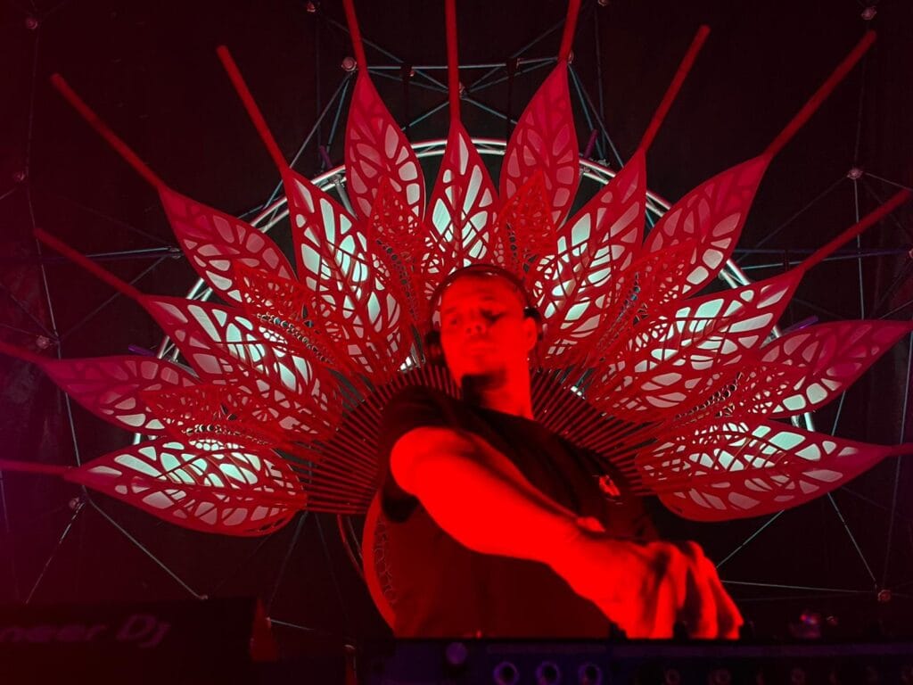 Tyler Hill At Harvest Fest 2023 Red lit DJ with star batik above him