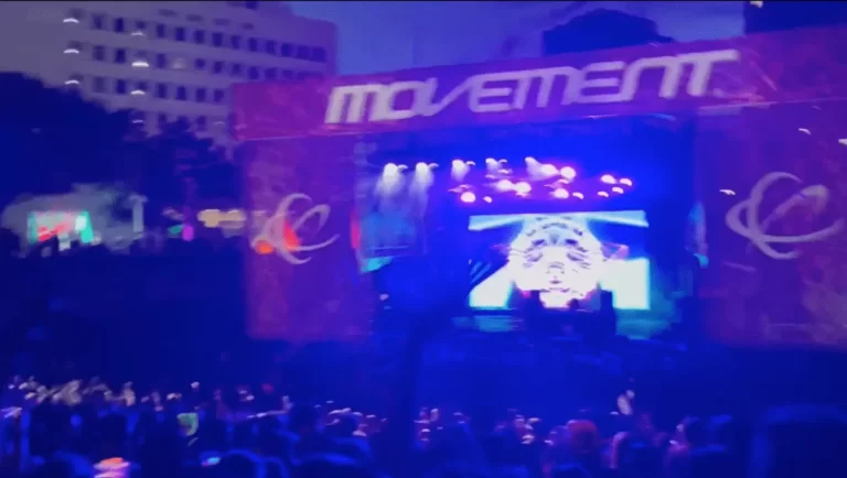 The crowd and festival stage in blue