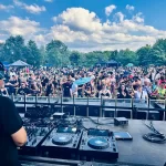 DJ Tyler Hill facing a crowd from stage at Electric Island, 2024